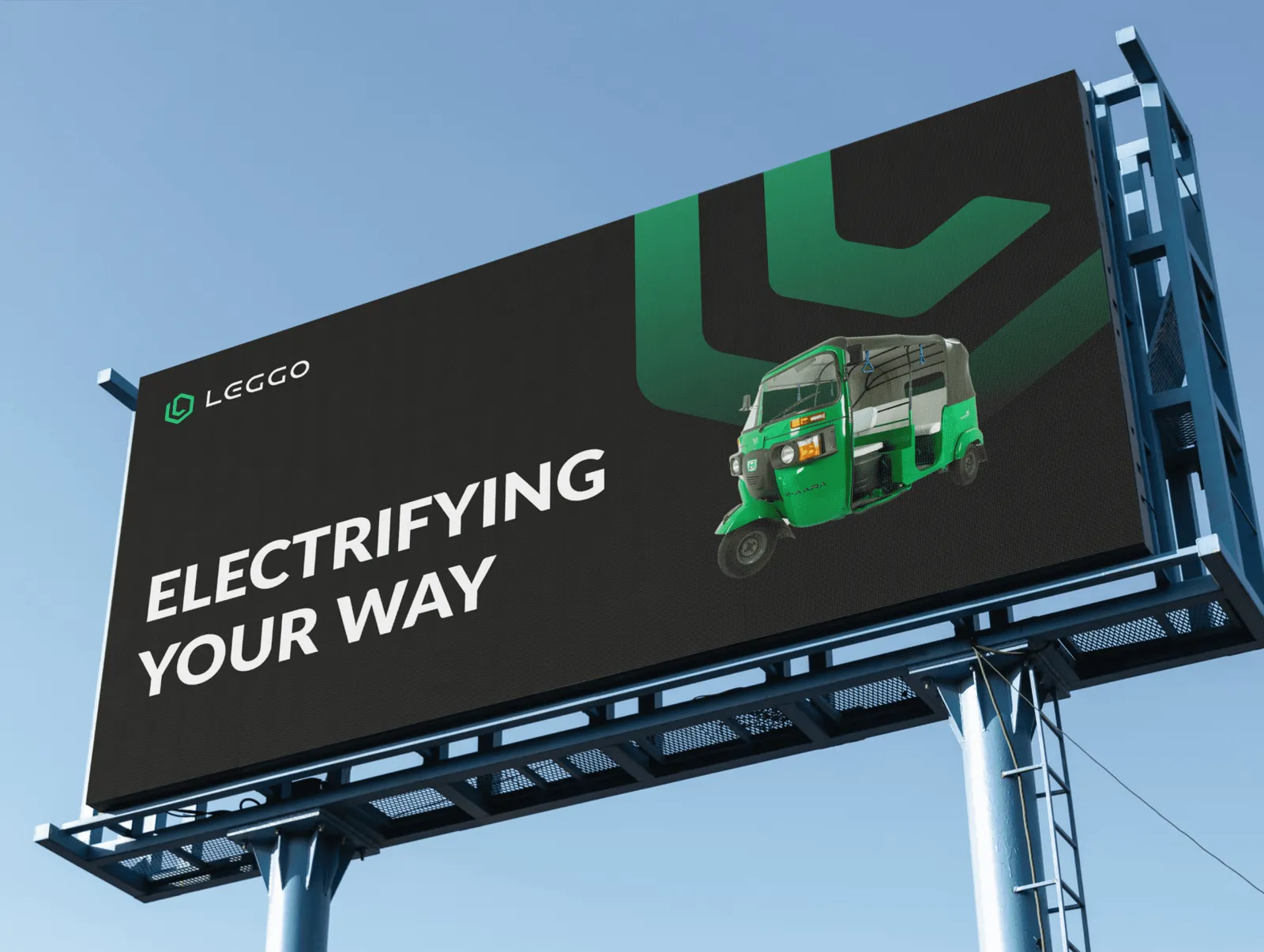 A Leggo billboard reading Electrifying your way, with a green auto