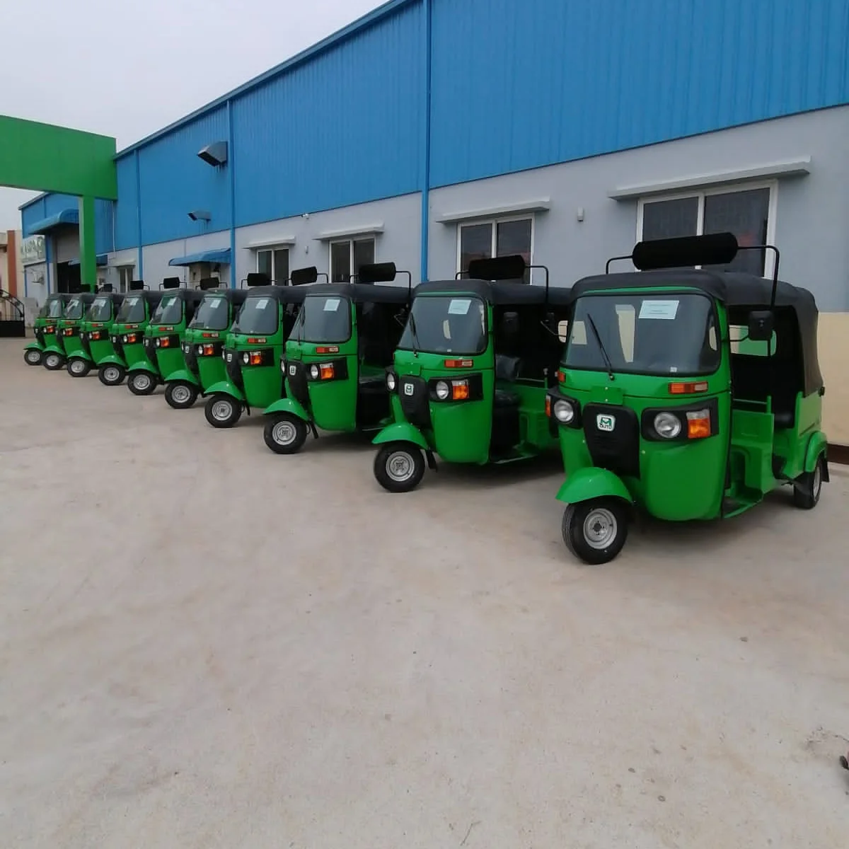 A long row of Leggo autos along a blue warehouse wall