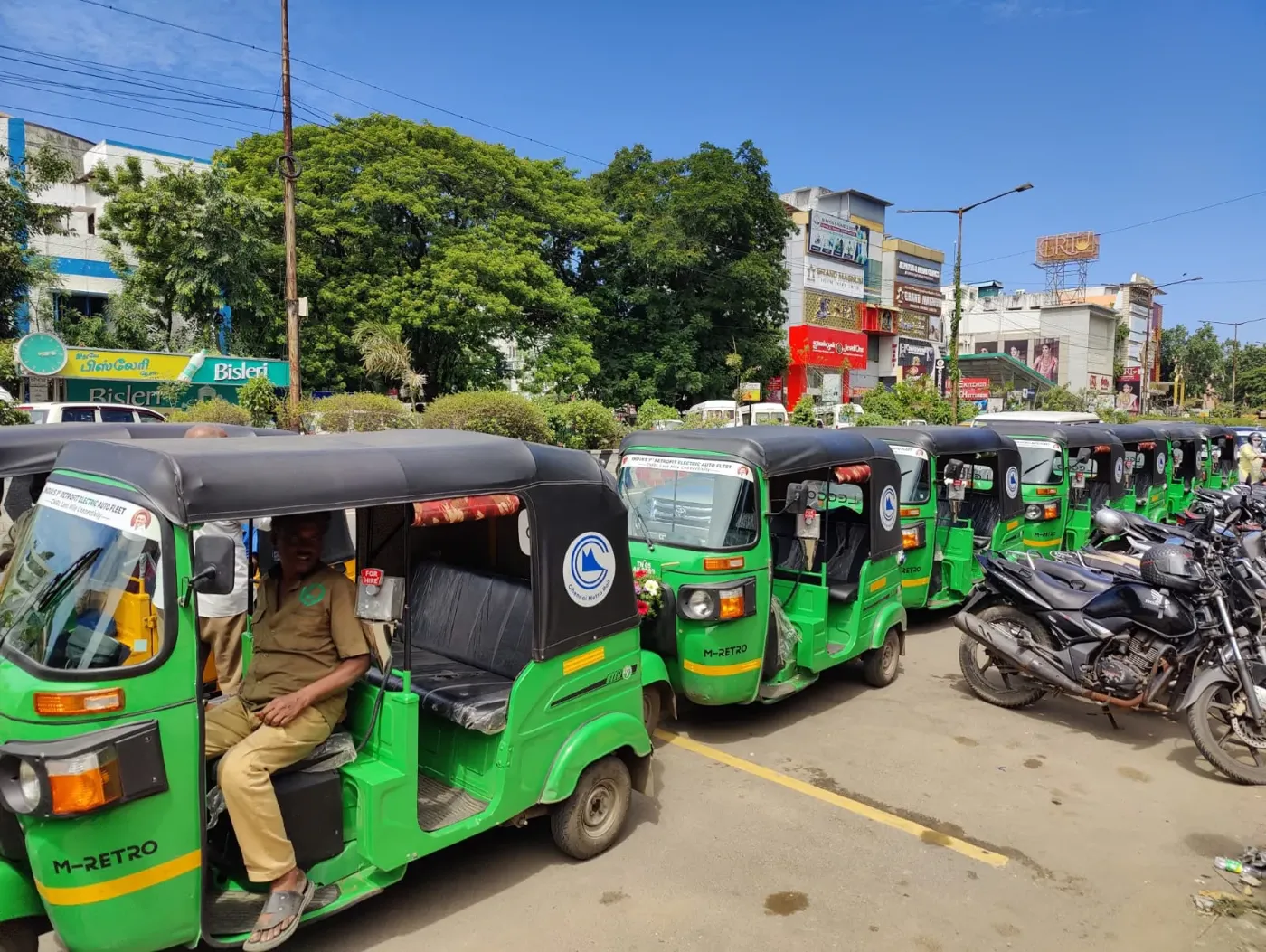 A row of green Leggo electric autos